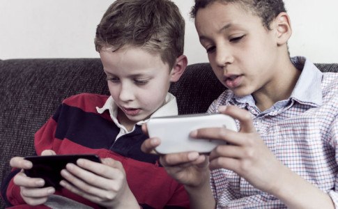 zwei Kinder schauen auf ein Smartphone