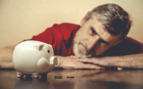 Senior mit Sparschwein