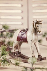 Wooden rocking horse on white table